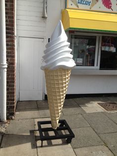 an ice cream cone sitting on top of a cart