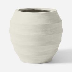 a white vase sitting on top of a table