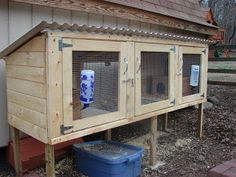 a chicken coop with two large windows and one small window on the side of it