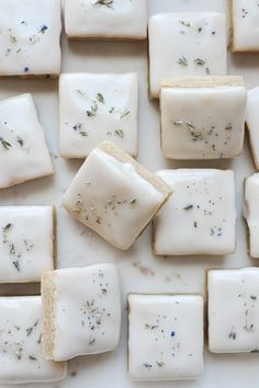 several pieces of soap sitting on top of a white counter next to other small squares