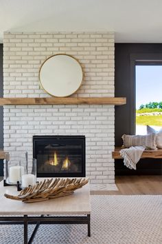 a living room with a white brick fireplace