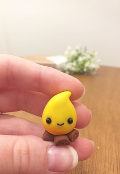 a small yellow toy sitting on top of a wooden table