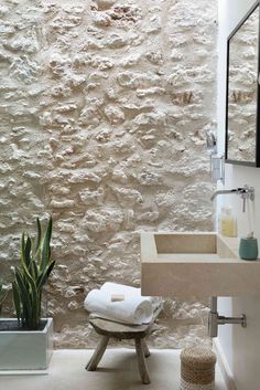 a bathroom with a sink, mirror and towel rack