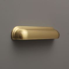 a gold door handle on a gray wall