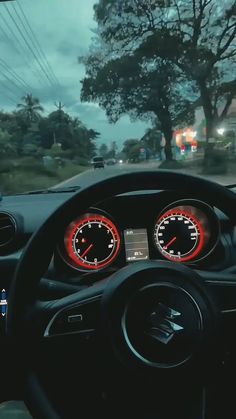 the dashboard of a car is lit up with red and white gauges on it