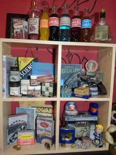 a shelf filled with lots of different types of liquor bottles and other items on top of it