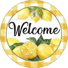 a welcome sign with lemons and leaves on a checkered tablecloth pattern background