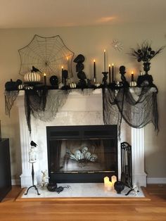 a living room filled with furniture and a fire place covered in black spider webs