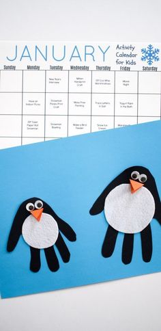 an image of a penguin calendar on a blue paper sheet with the word january written in it