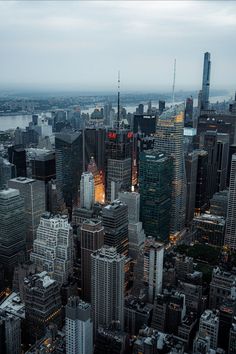 an aerial view of the city lights and skyscrapers in new york, ny at night