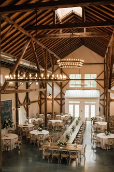 the inside of a large building with tables and chairs set up for a formal function