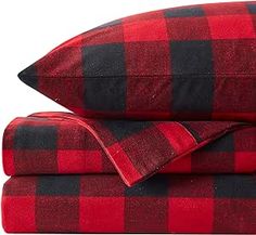 two red and black plaid sheets on top of each other, one is folded up