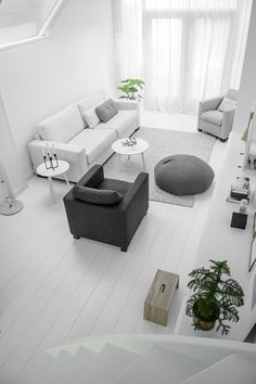 a living room filled with furniture and white walls