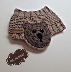 a crocheted hat with a bear on it