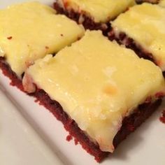 four pieces of red velvet cake on a white plate