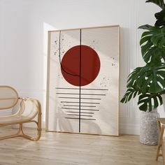 an abstract painting on the wall next to a chair and potted plant in a white room