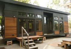 the front page of this magazine features an image of a small house with wood siding and windows