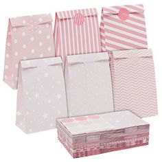 pink and white paper bags with polka dots, stars and stripes on them are stacked up in rows