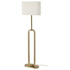 a floor lamp with a white shade on the base and a gold metal frame around it