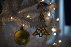 a christmas tree with ornaments hanging from it's branches