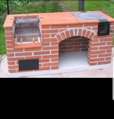 an outdoor brick pizza oven built into the ground