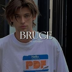 a young man wearing a white t - shirt with the words bruce on it in front of him