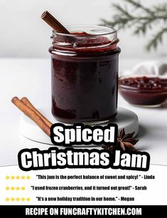 a jar filled with jam sitting on top of a white table next to a cinnamon stick