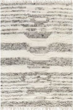 an area rug with grey and white stripes on the side, including fringes in different sizes