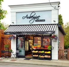 an outside view of a grocery store with fruit and vegetables on the display shelves in front