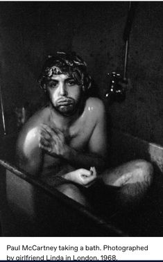 a man sitting in a bathtub with his hands crossed