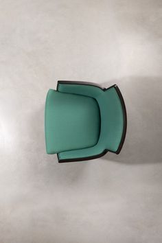 a green chair sitting on top of a white floor