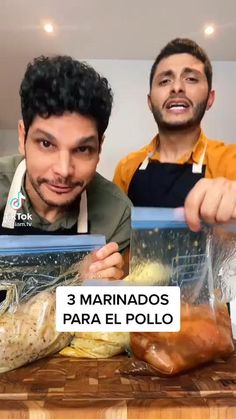 two men standing behind a table with food on it and one holding up a sign that says 3 marinados para el pollo