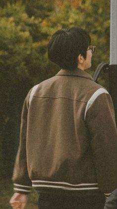 a man standing next to a street sign