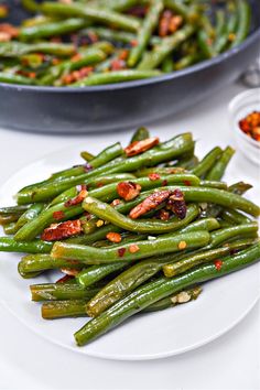 green beans with spices and seasoning on a white plate