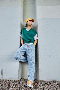 Stock Image: Vertical portrait of young Asian man wearing colorful street style clothes standing by concrete wall in urban setting Queer Street Style, Japan Street Style Men, Colorful Androgynous Fashion, Mens Outfits Plus Size, Taiwan Street Fashion, Mens Skater Style, Dr Lemon, Photoshoot Fits, Hip Hop Style Men