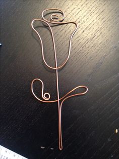 a piece of wire sitting on top of a wooden table