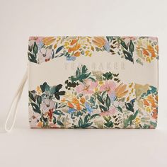 a floral print wallet with the word ted baker on it's front and side