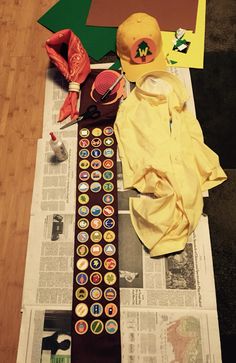 a hat, baseball cap and other items are laying on top of the newspaper next to each other