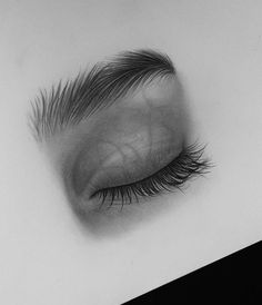 a black and white photo of an eye with long lashes