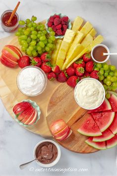 a wooden platter filled with fruit and dips