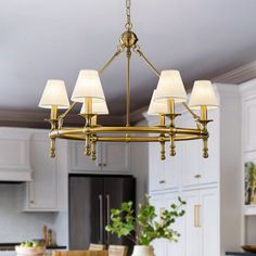 a chandelier hanging from the ceiling in a kitchen