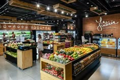 the interior of a grocery store filled with fruits and vegetables