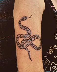 a woman with a snake tattoo on her arm