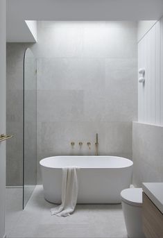 a white bath tub sitting next to a walk in shower