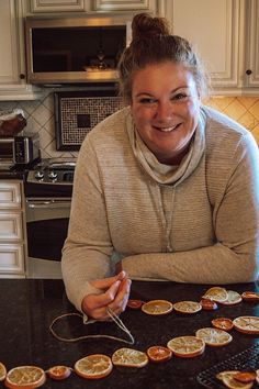 a woman sitting at a kitchen counter with some food on the table in front of her