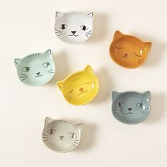 four cat shaped dishes sitting on top of a table