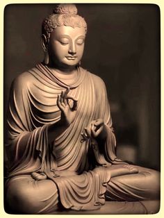 a buddha statue sitting in the middle of a room