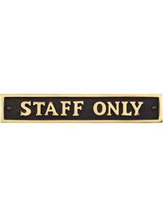 a black and gold sign that says staff only