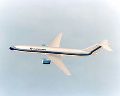 an airplane is flying in the sky on a clear day with blue and white stripes