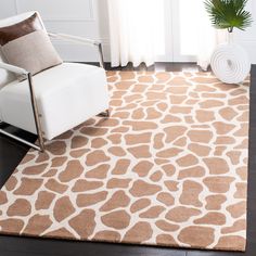 a giraffe print rug with a chair in the corner and a potted plant next to it